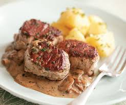 Pork tenderloin medallions in vinsanto sweet sauce with mushrooms and pine nuts