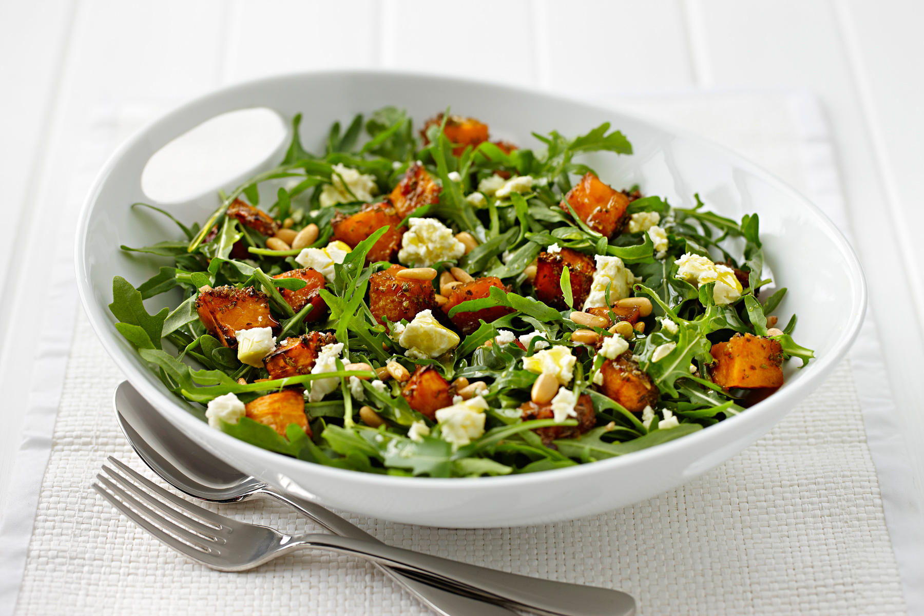 Rocket salad with sun dried tomato, home made rusk, fresh orange cubes, walnut crumbles, parmesan flakes & vinaigrette sauce